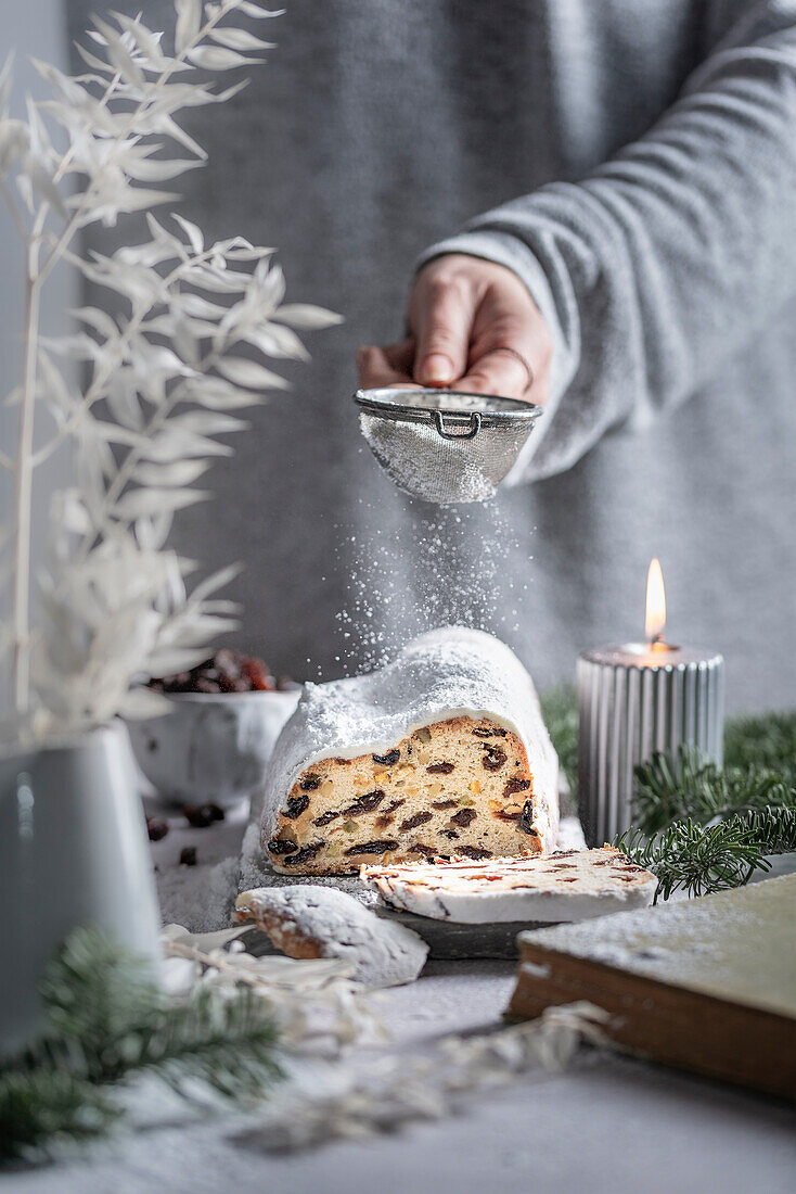 Christstollen mit Puderzucker bestäuben