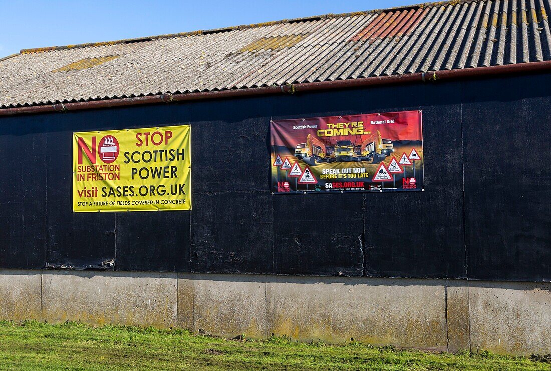Protest campaign banners against electricity substation