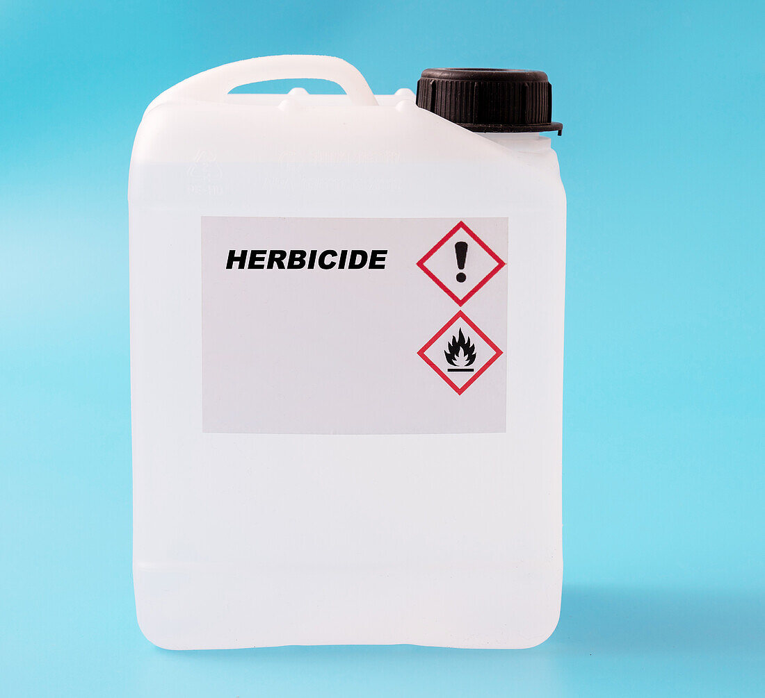 Herbicide in a plastic canister, conceptual image