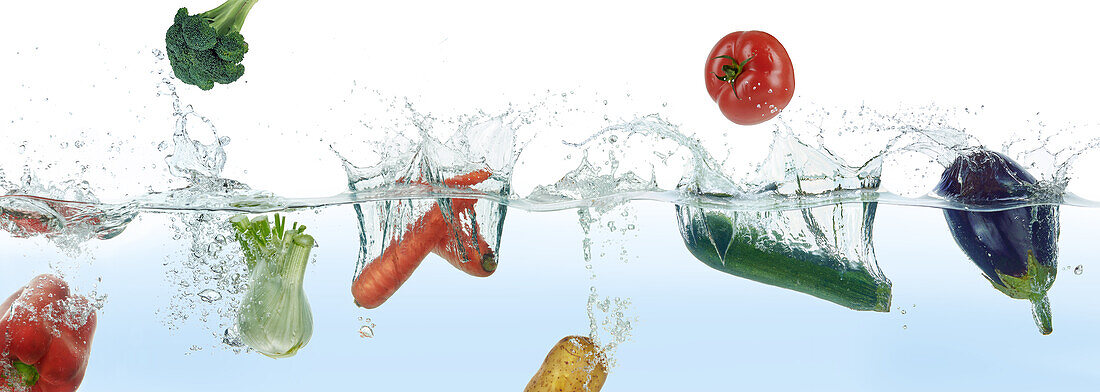 Vegetables splashing in water