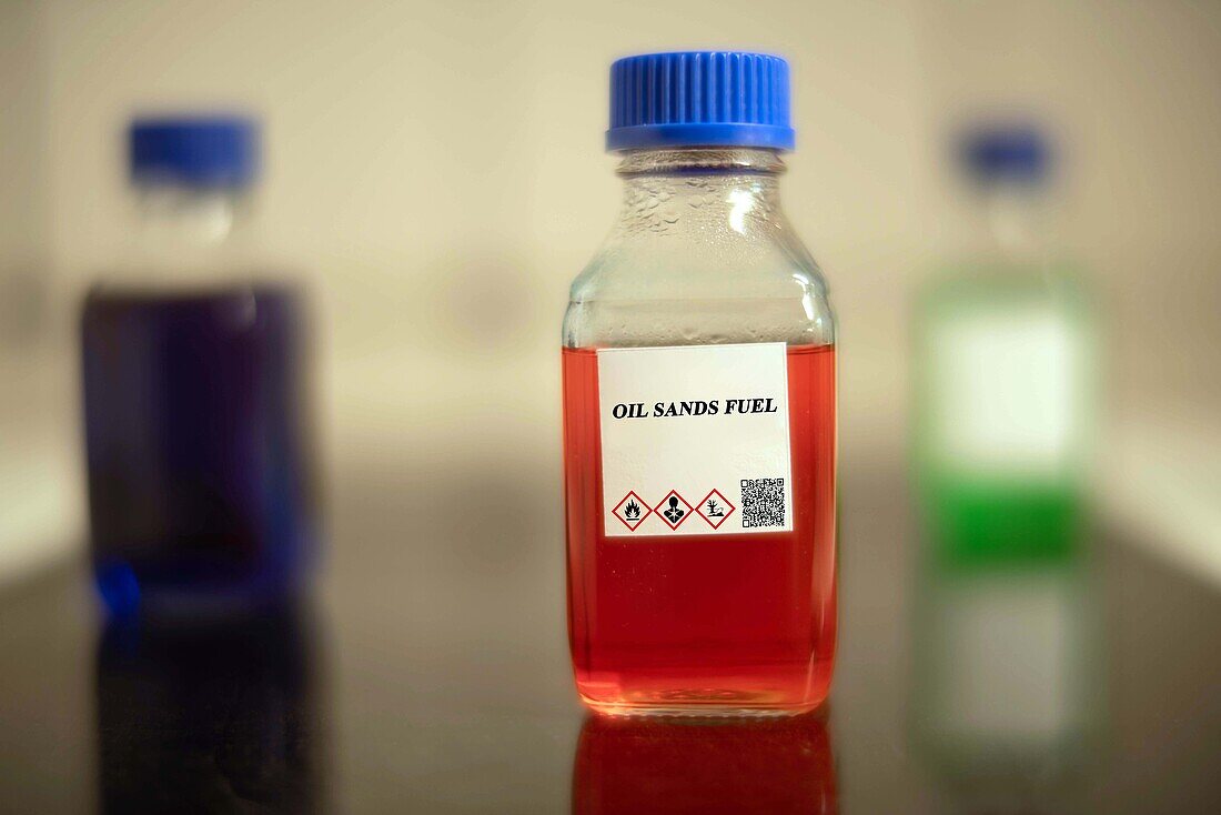 Glass bottle of oil sands fuel