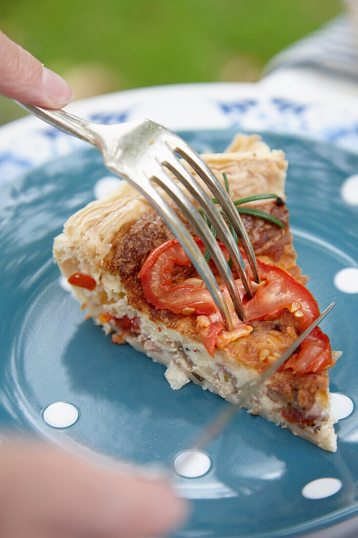 Piece of quiche with tomato