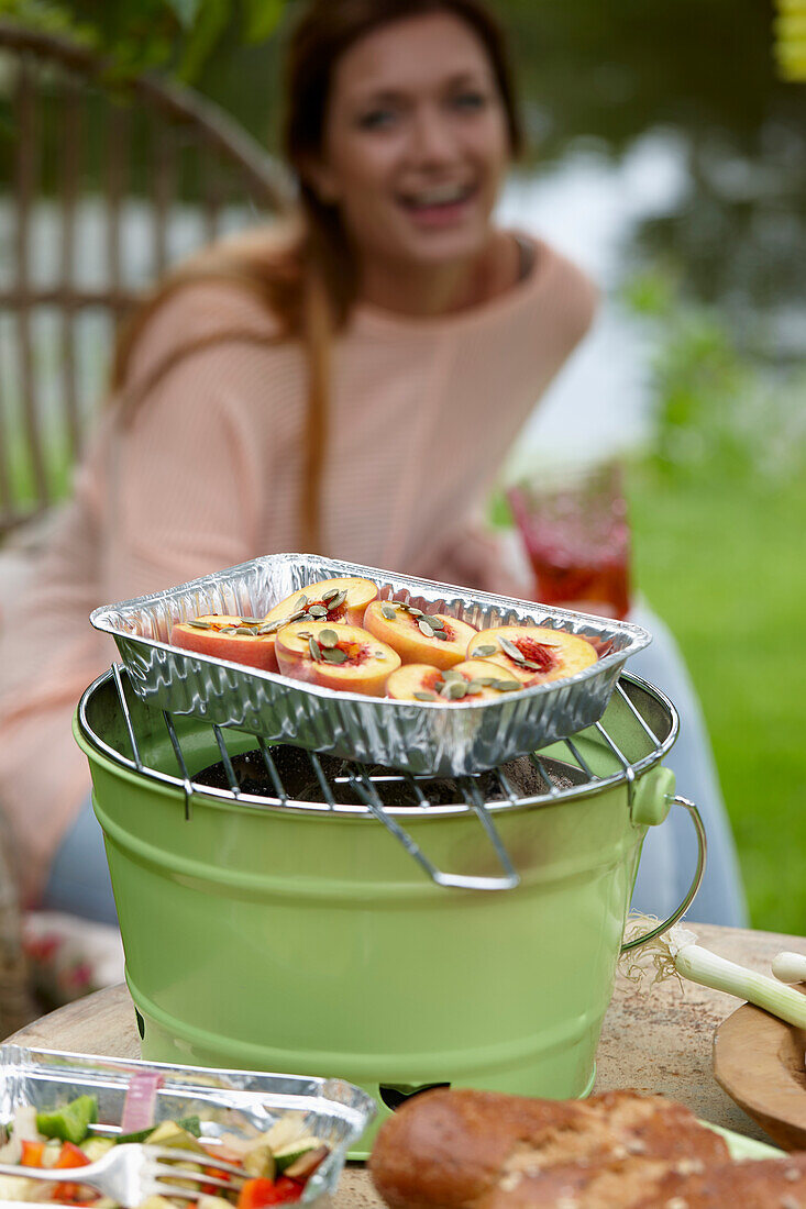 Halved peaches on grill