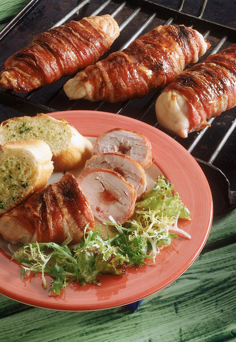 Grilled chicken rolls with redcurrant jelly, wrapped in bacon