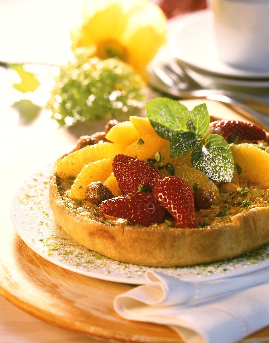 Strawberry and orange tartlet with pistachios & lemon balm
