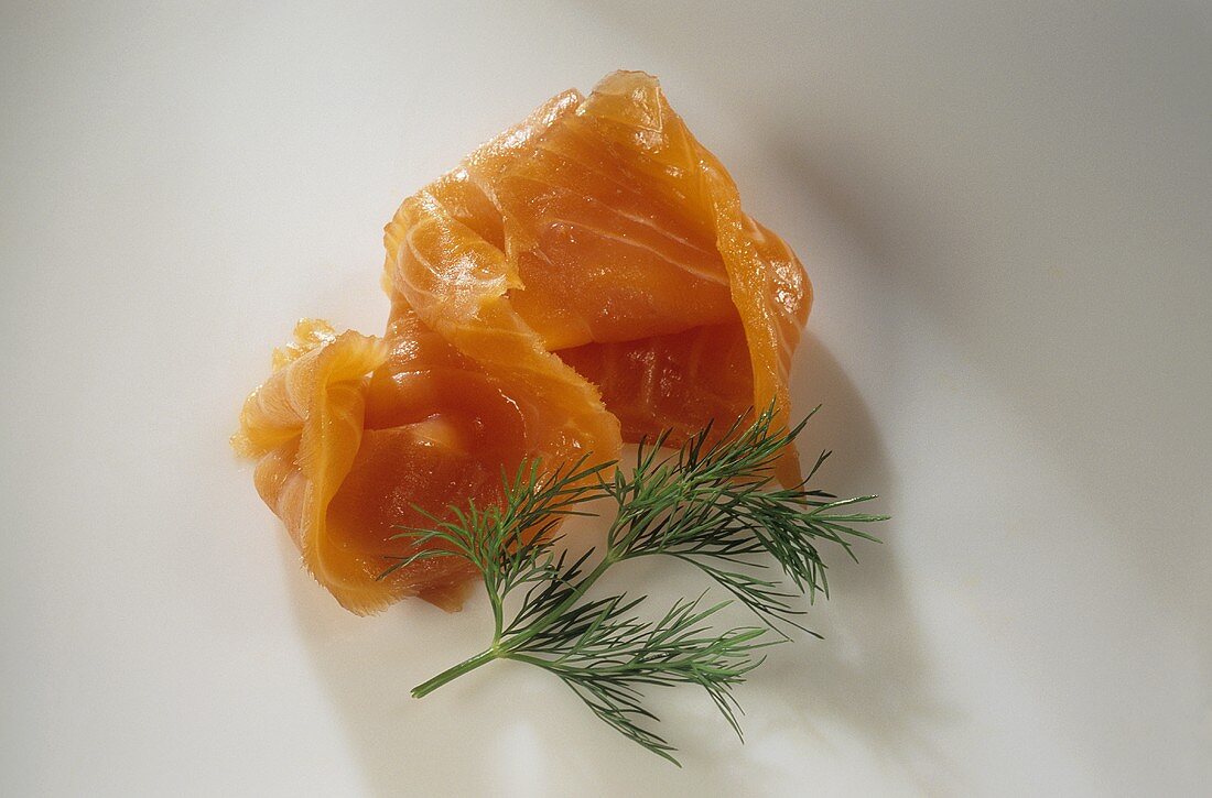 A slice of smoked salmon and sprig of dill