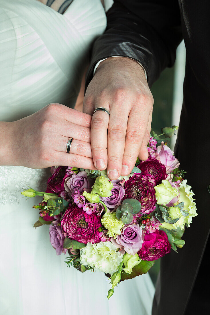 Bridal bouquet, hands with rings