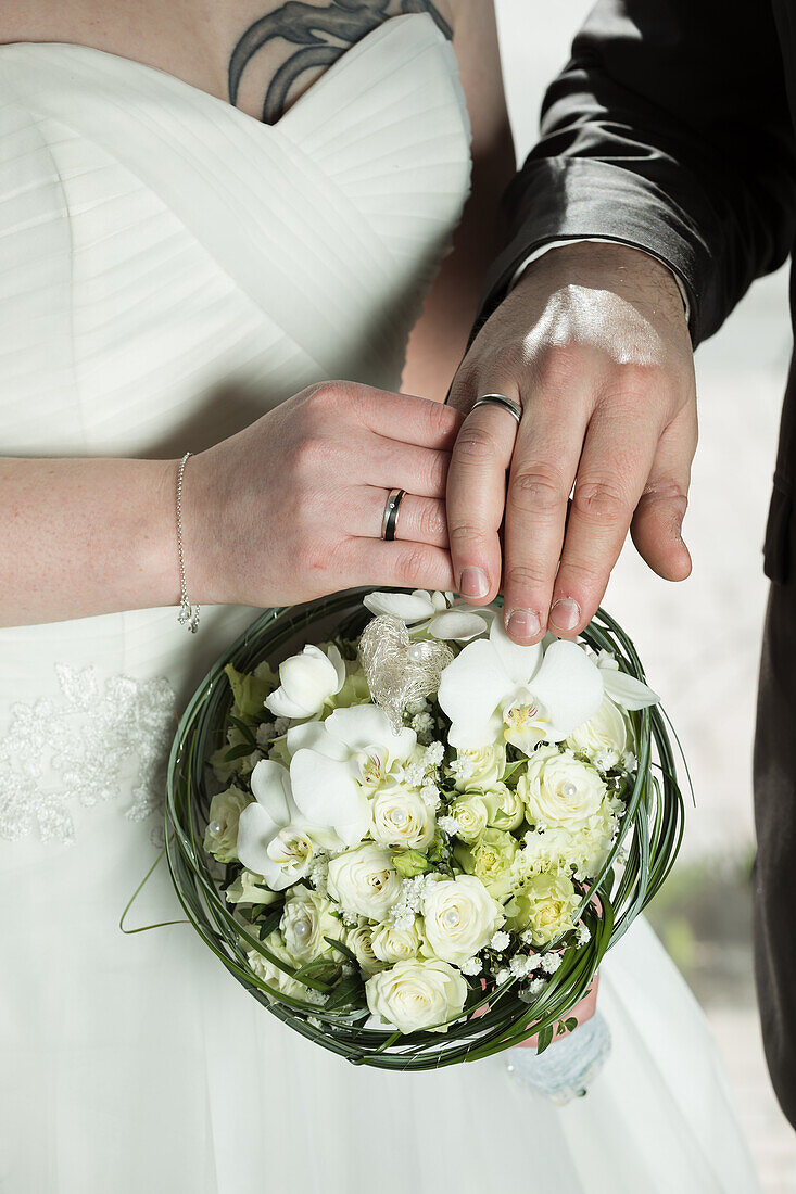 Bridal bouquet, hands with rings