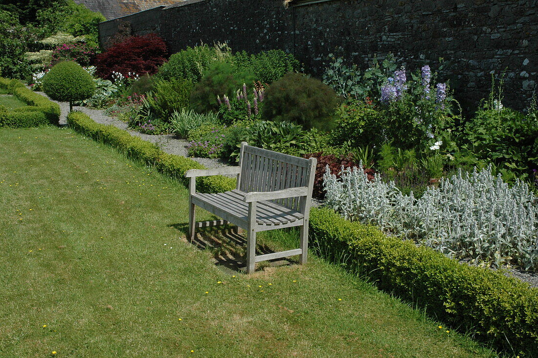 Bench in front of shrub bed