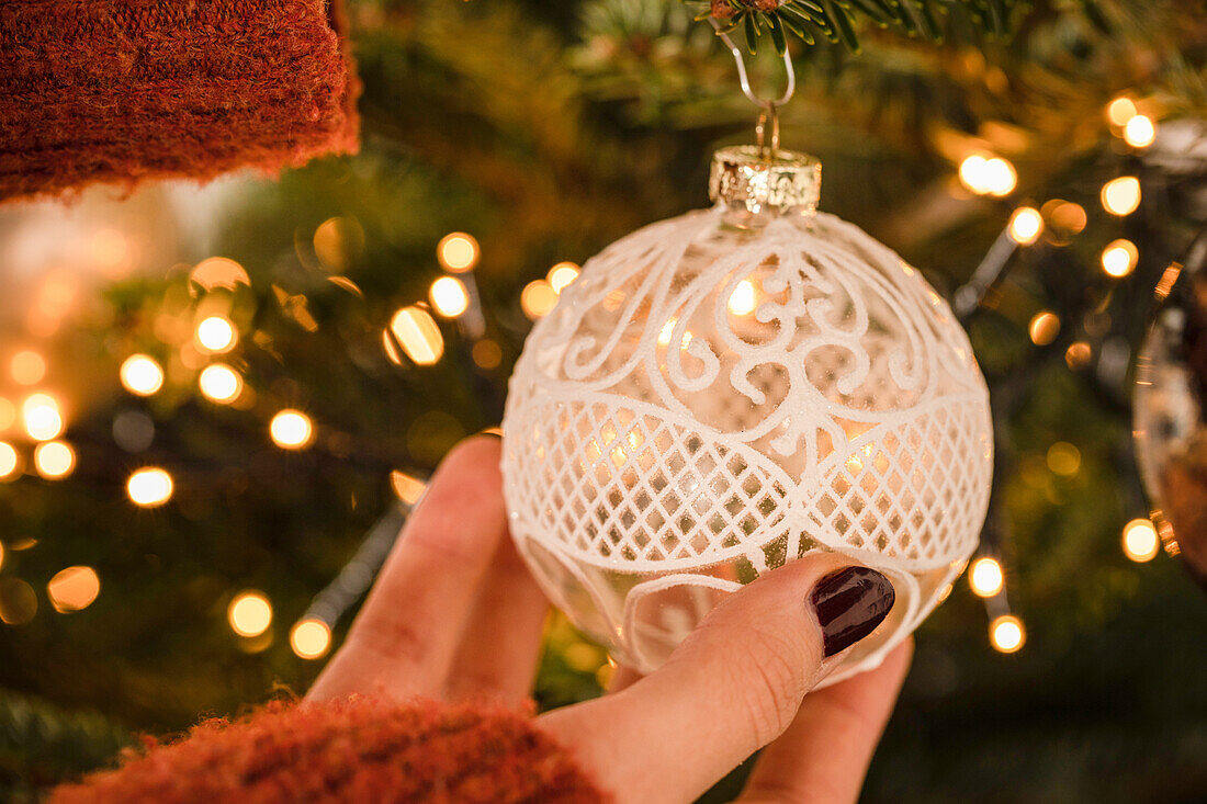 Hanging up the Christmas tree ball