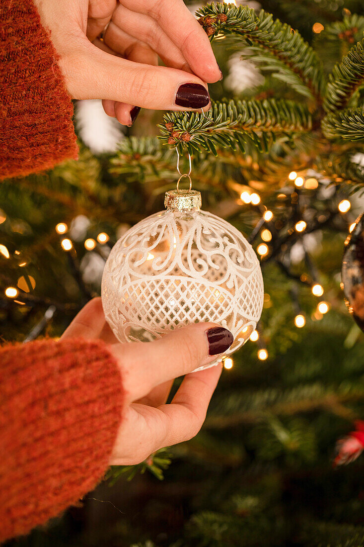Hanging up the Christmas tree ball