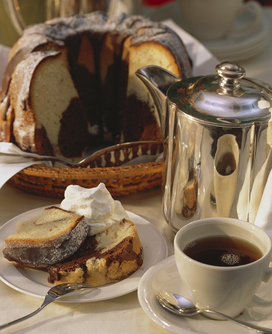 Marble cake with marzipan, pieces cut and cup of coffee