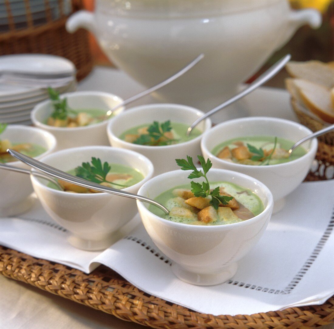 Peas soup with salmon strips & croutons in bowl