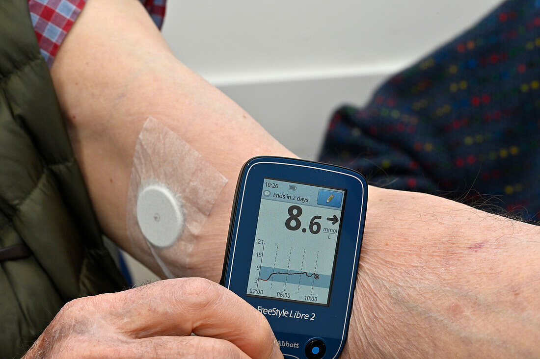 Patient reading a continuous glucose monitor