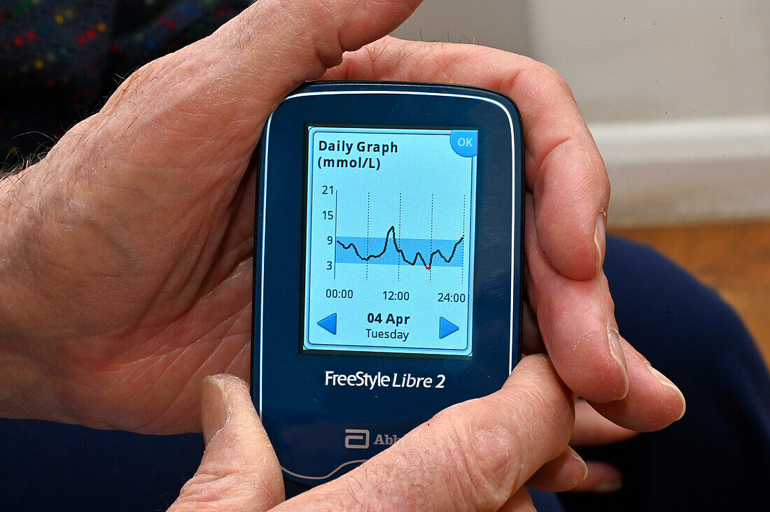 Patient reading a continuous glucose monitor