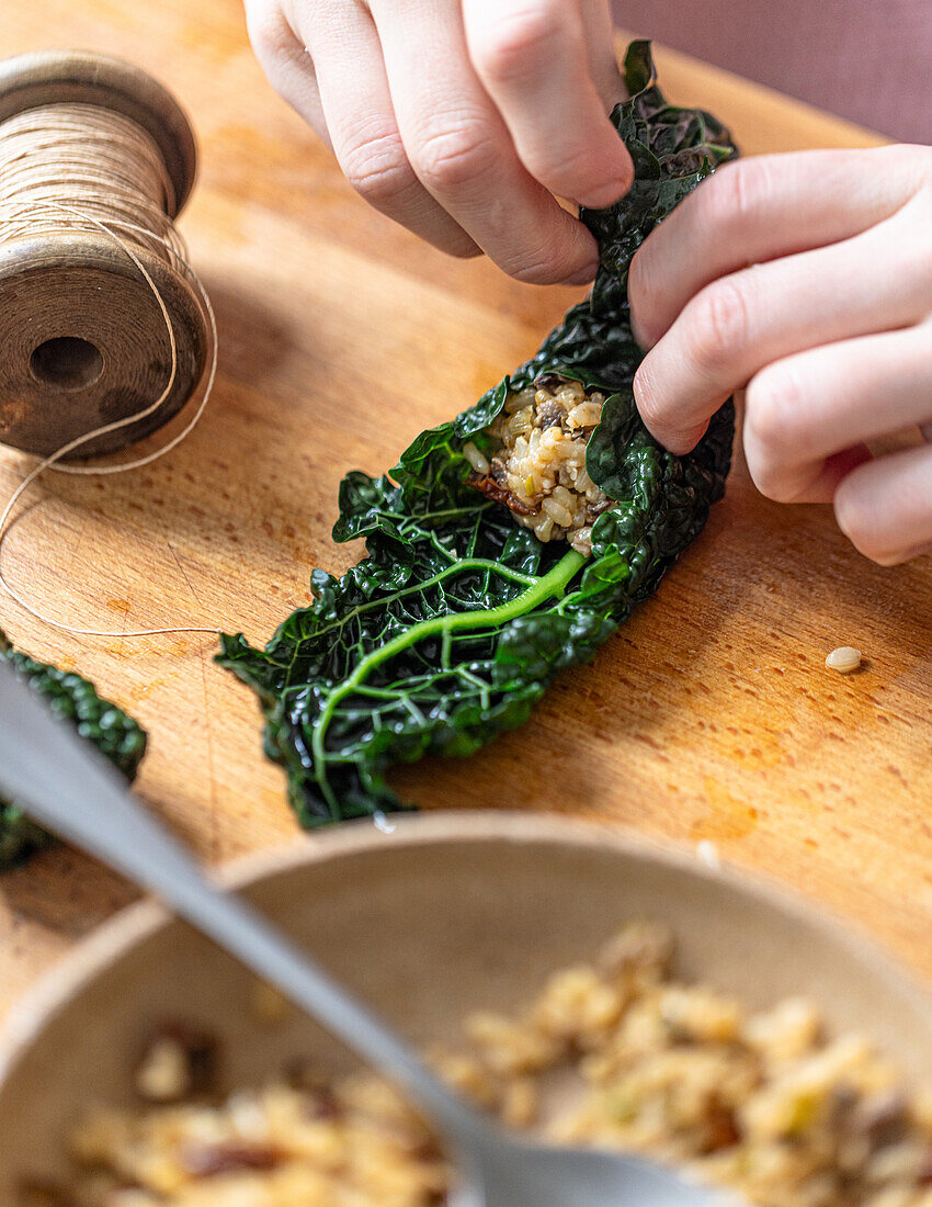 Preparing cabbage wraps with rice filling