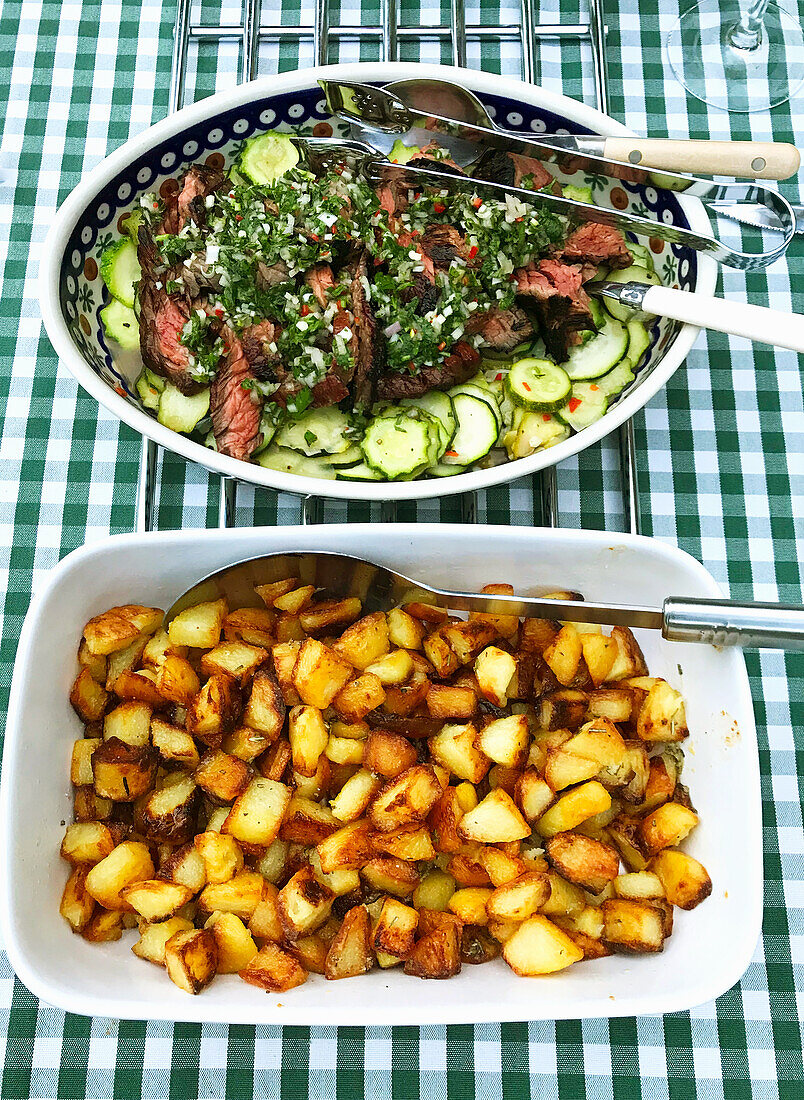 Sliced beef steak with chimchurri and roast potatoes