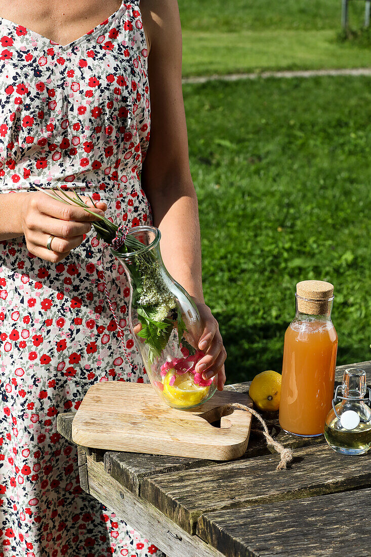 Preparing wild herb tea with rose petals