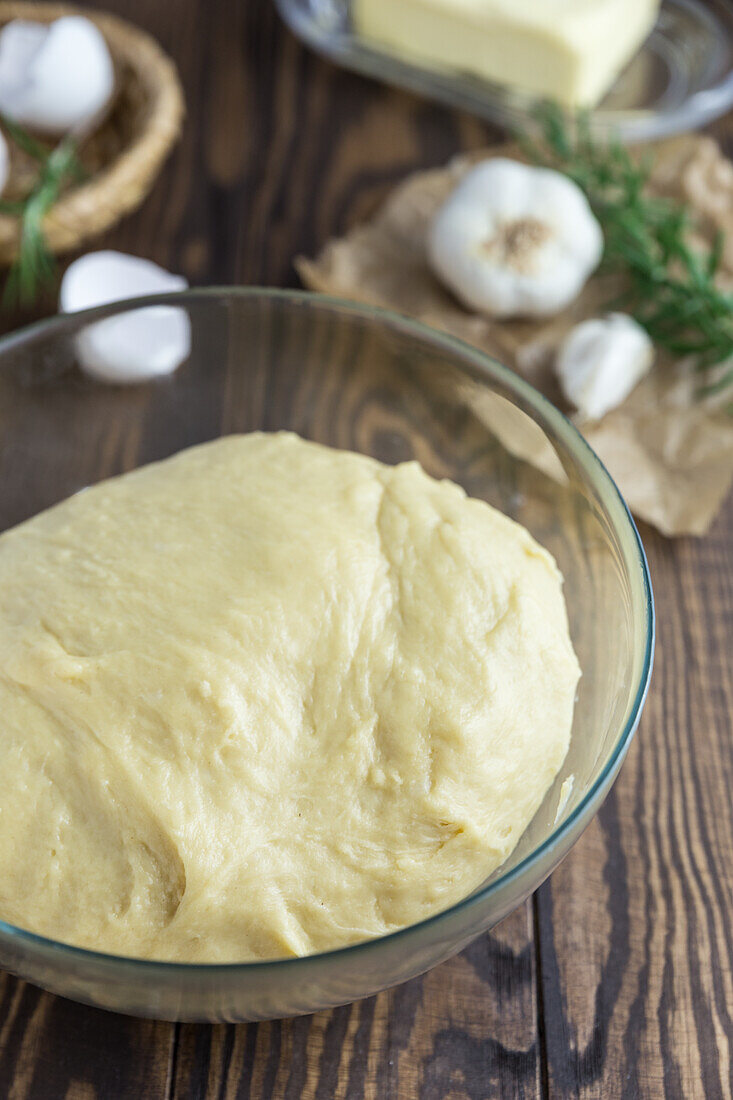 Risen yeast dough in a glass bowl