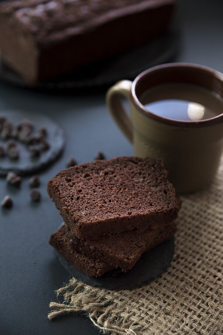 Chocolate banana bread next to a cup of coffee