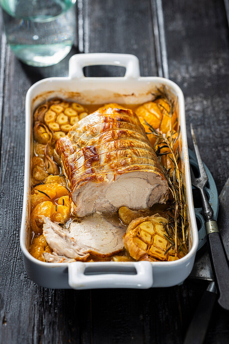 Pork roll roast with mandarins and garlic