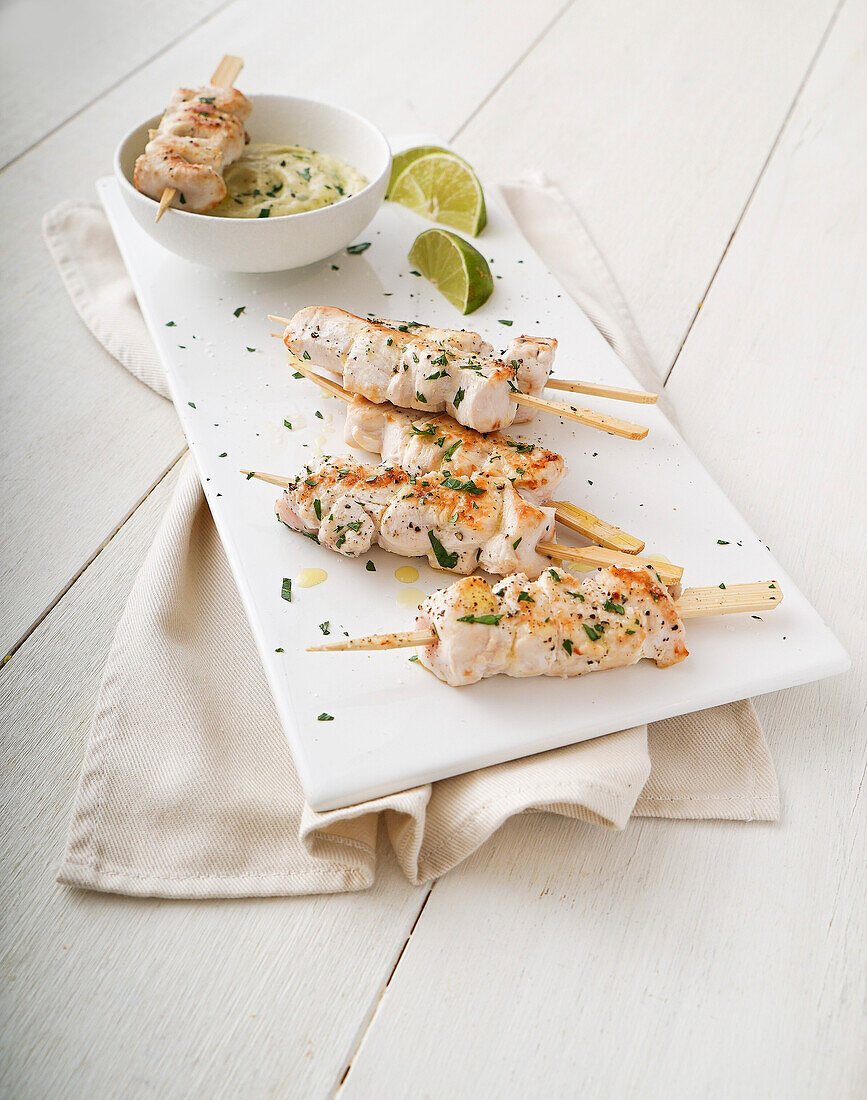 Lime chicken skewers with tuna and caper cream
