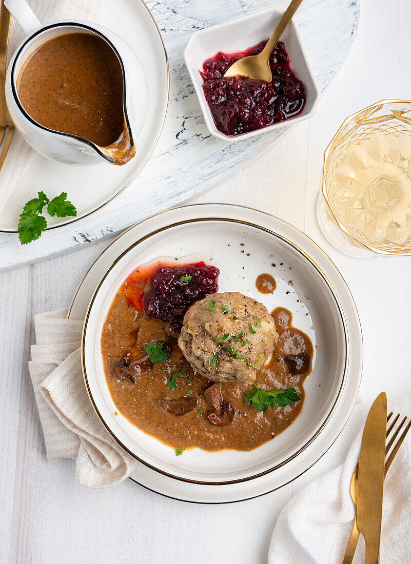 Vegan bread dumplings with mushroom sauce and wild cranberries