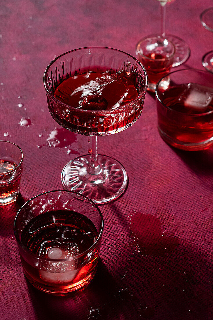 Raspberry falls into red cocktail