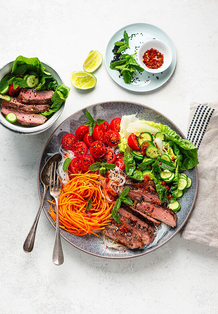 Rice noodle and vegetable bowl with beef steak