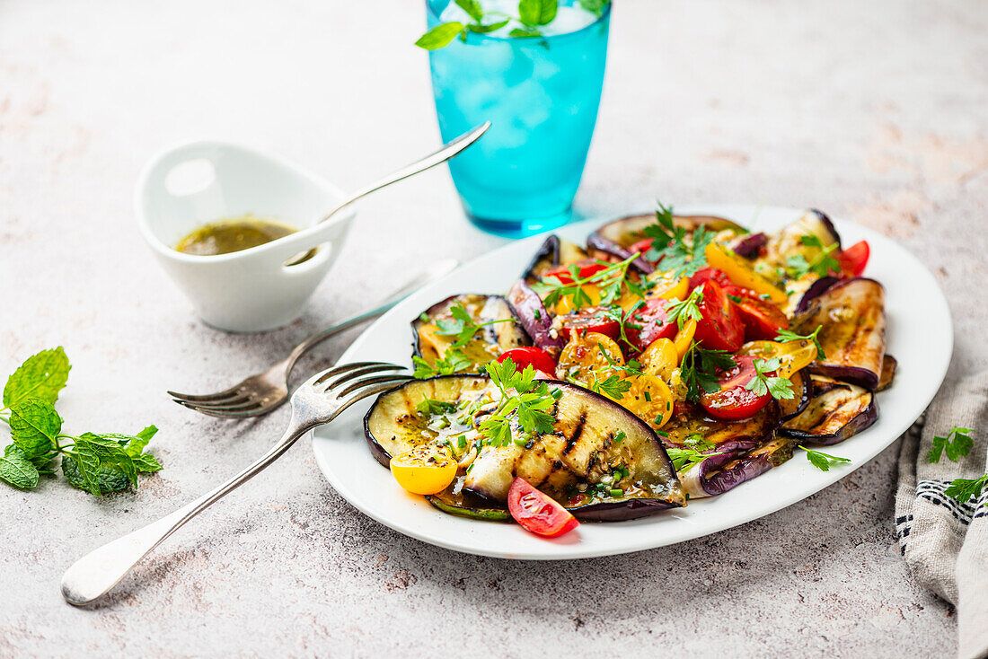 Grilled aubergine and tomato salad