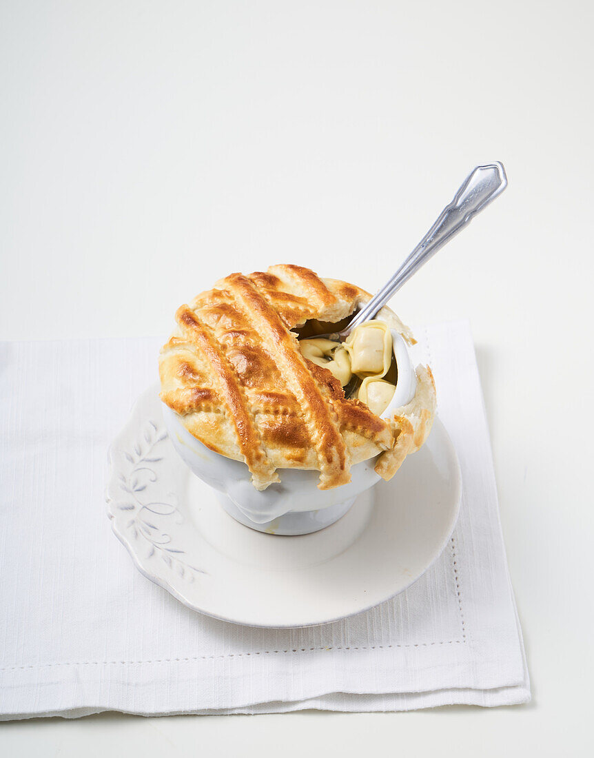 Tortellini in broth with puff pastry topping