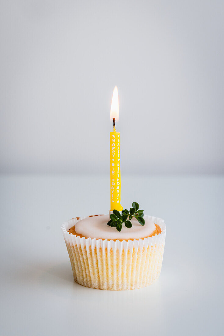 Lemon and thyme cupcake with mini birthday candle