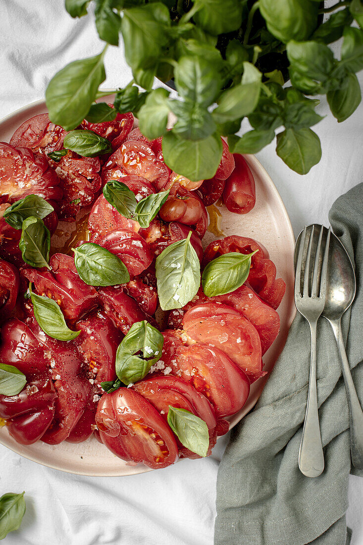 Tomato salad with basil, sea salt flakes and olive oil