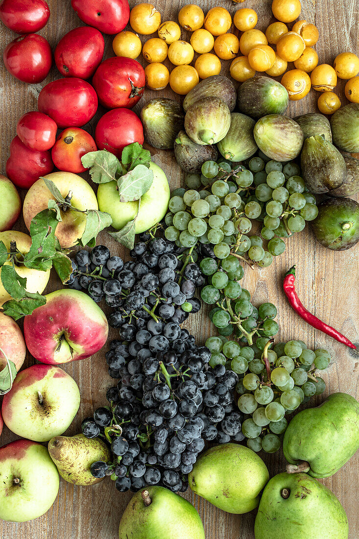 Late summer fruit and vegetables on a wooden board