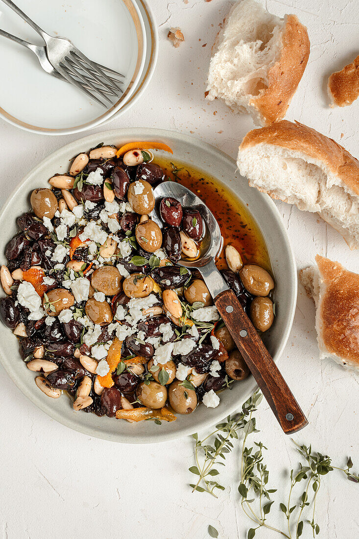 Süß sauer marinierte Oliven mit Feta, frischem Thymian und Weißbrot