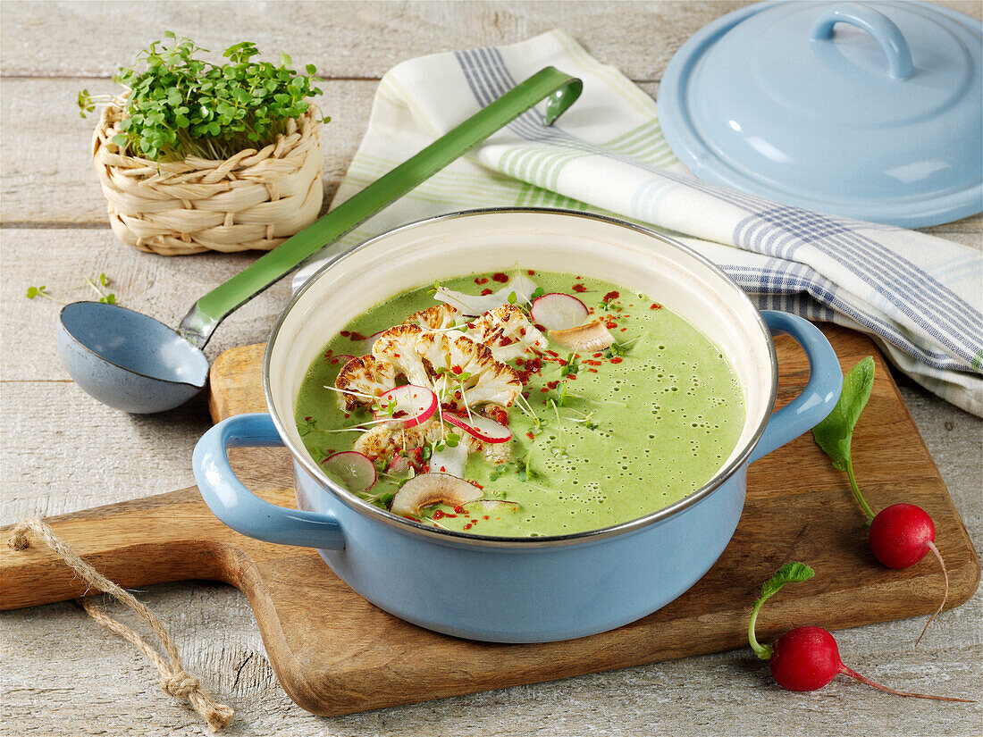 Creamy cauliflower soup with coconut and radishes