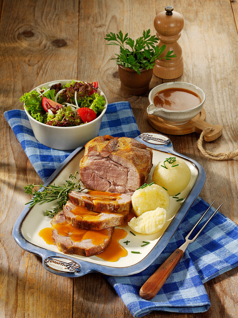 Braised roast pork with potato dumplings and salad