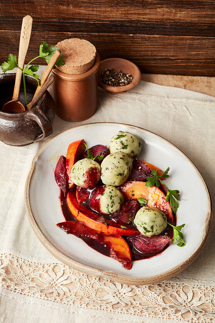 Vegan parsley dumplings with red onion and pumpkin ragout