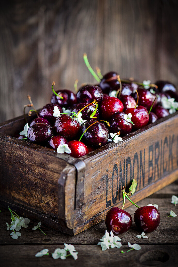 Wooden box with fresh cherries