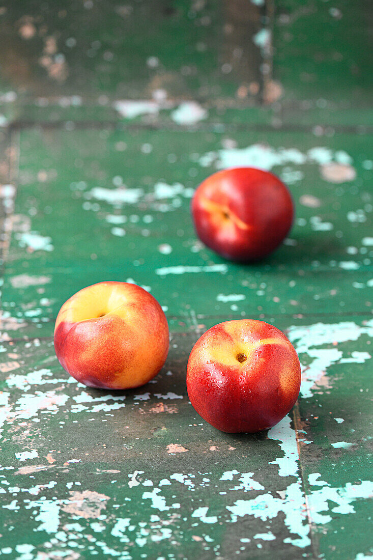 Nectarine on a green background