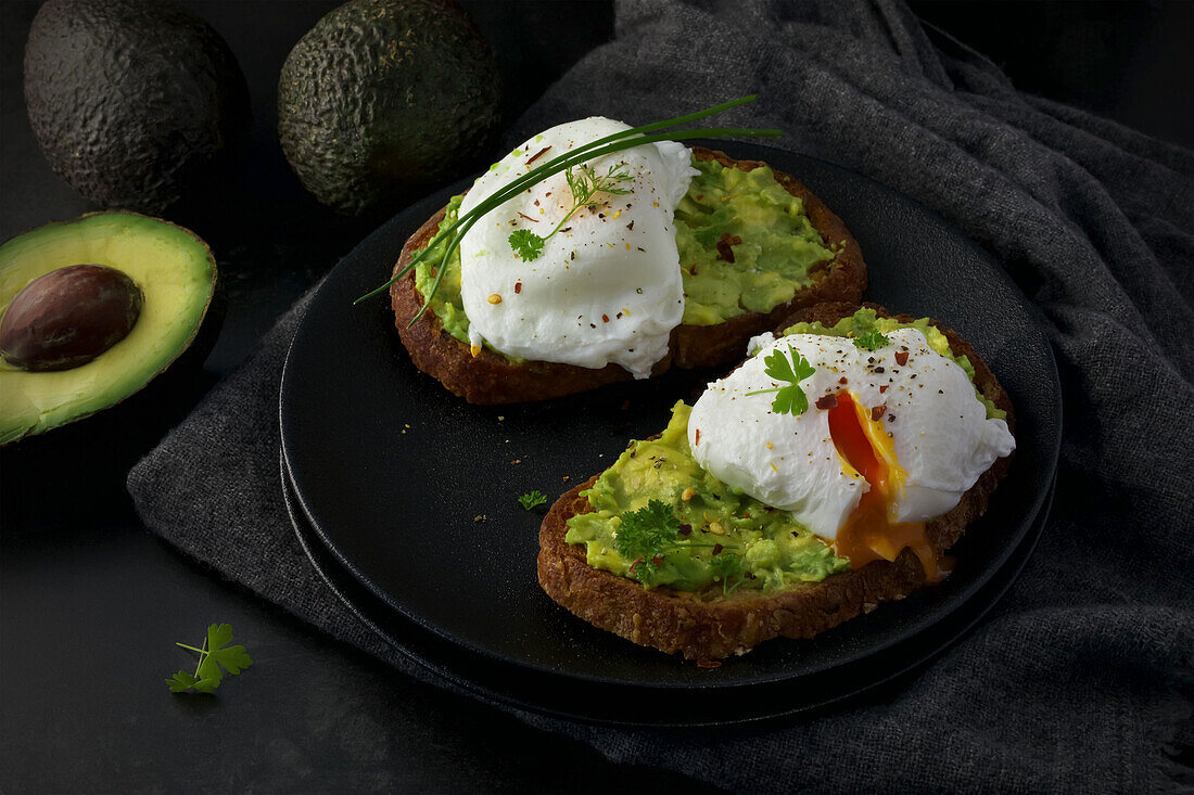 Two slices of sourdough bread with avocado mousse and poached eggs