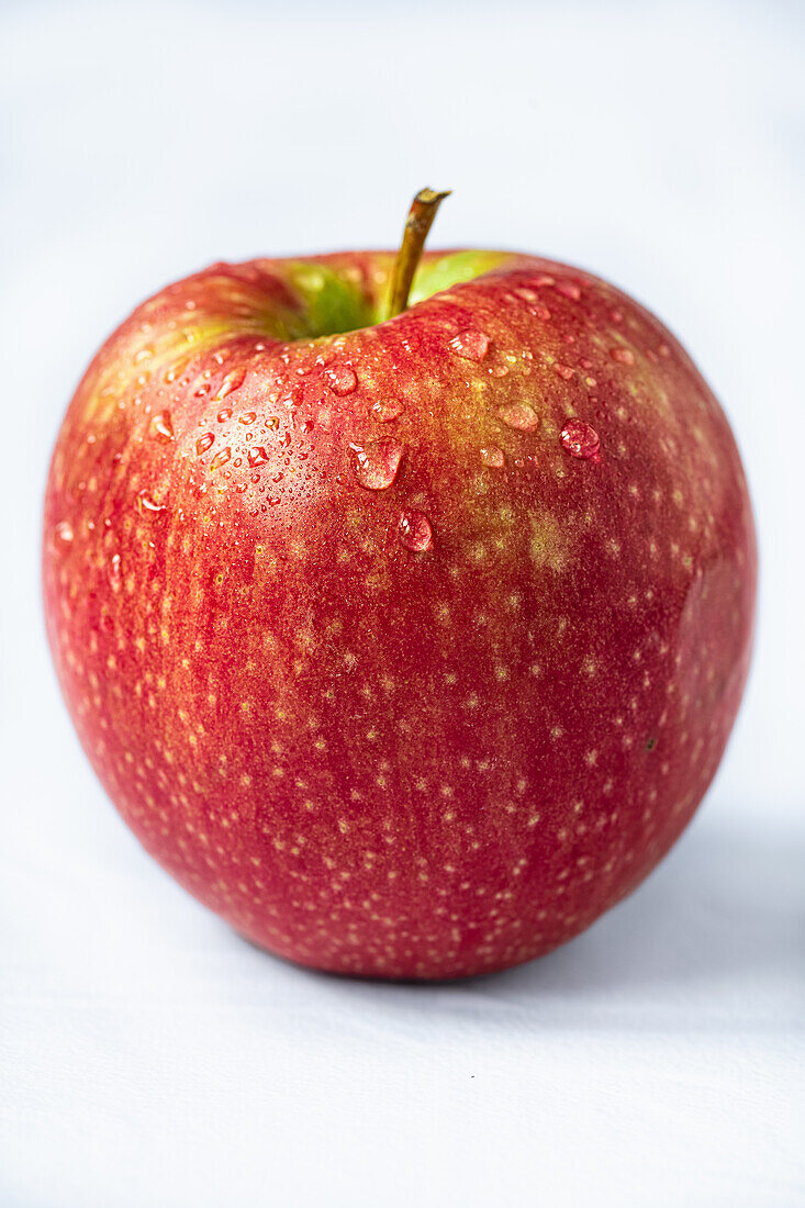 Close-up of a red apple with drops of water