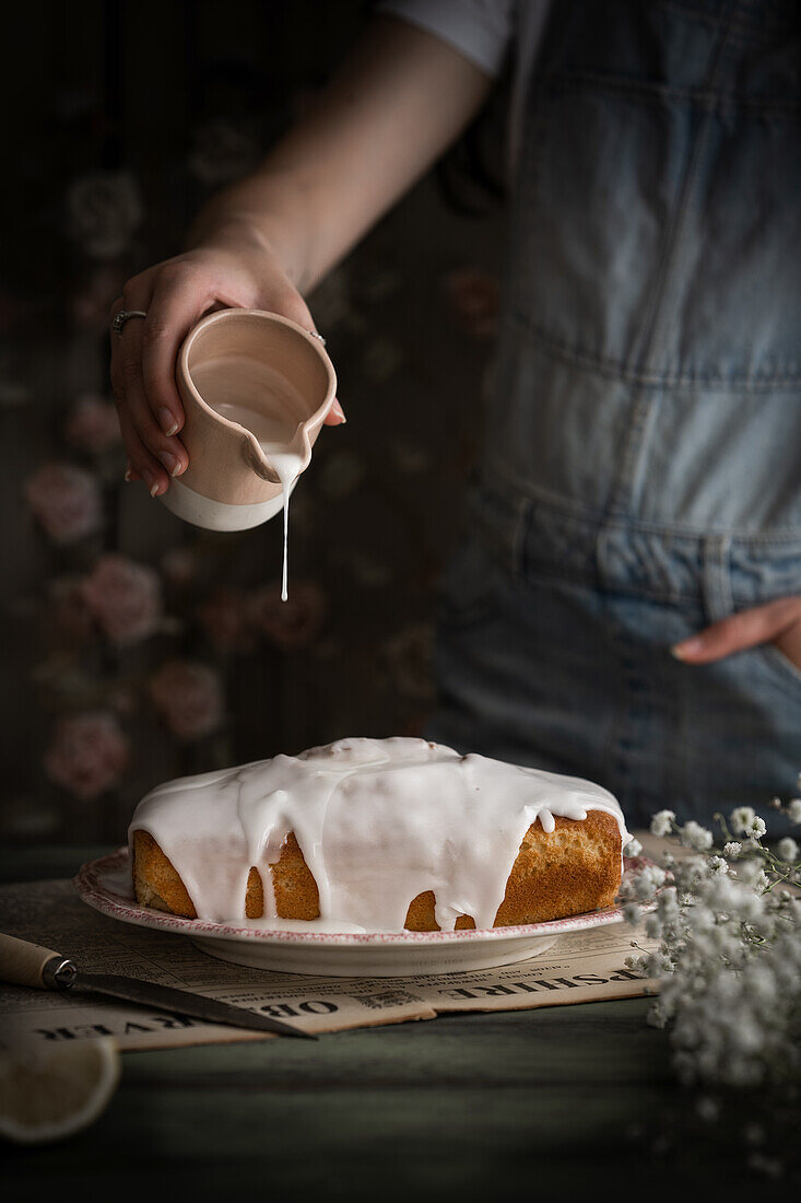 Pour lemon icing over lemon cake