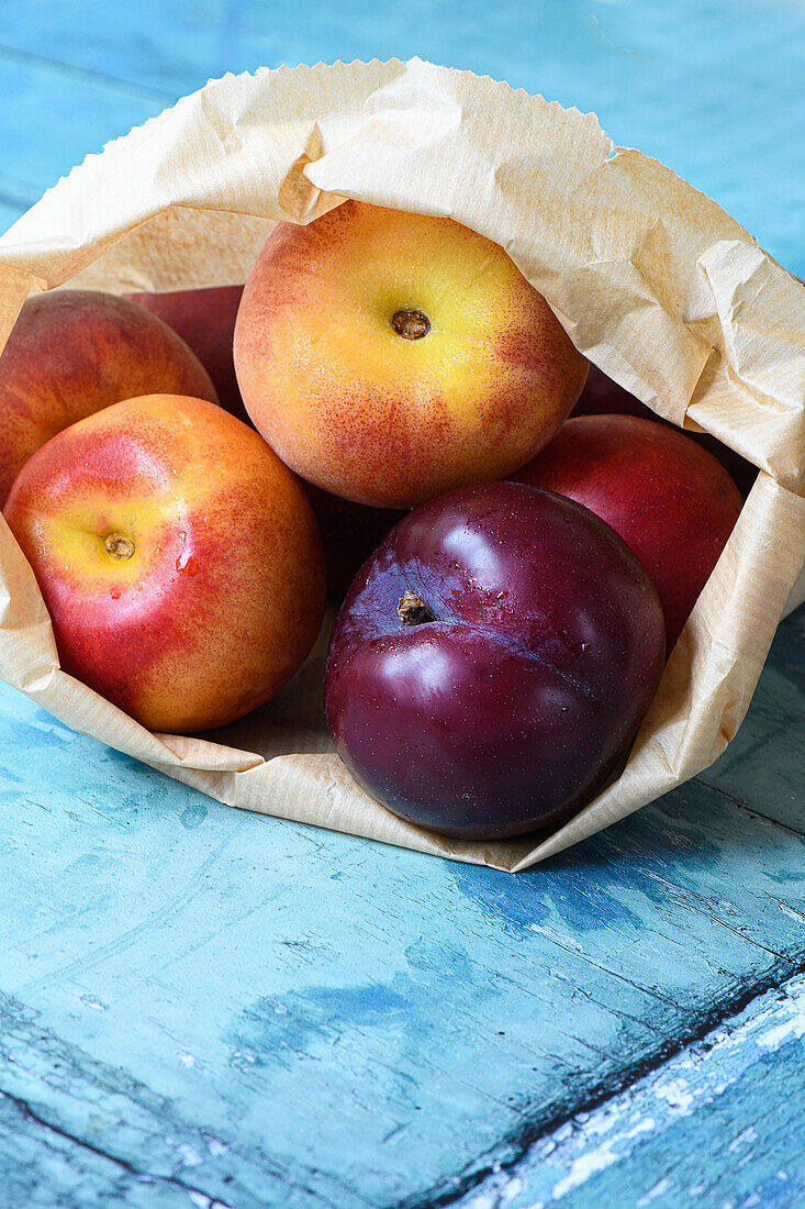 Peaches and plums in a paper bag