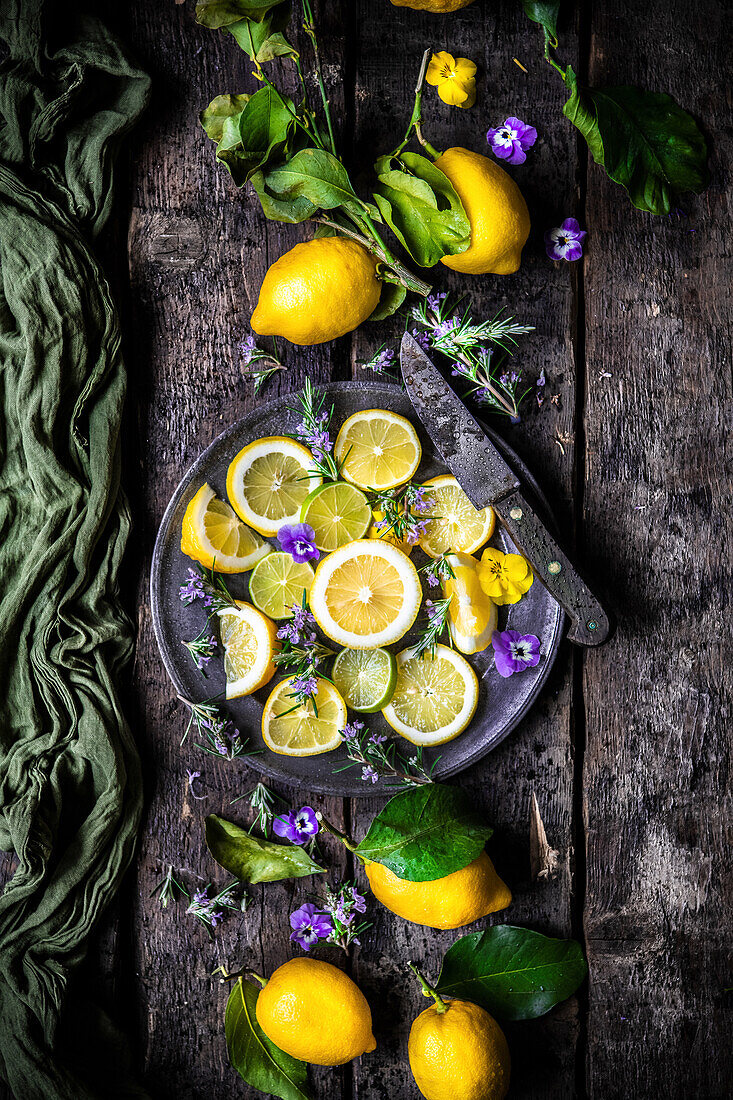 Sliced lemons, limes and edible flowers