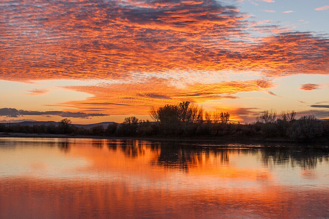 Colorful sunset skies reflected in the Green River near Jensen, Utah.