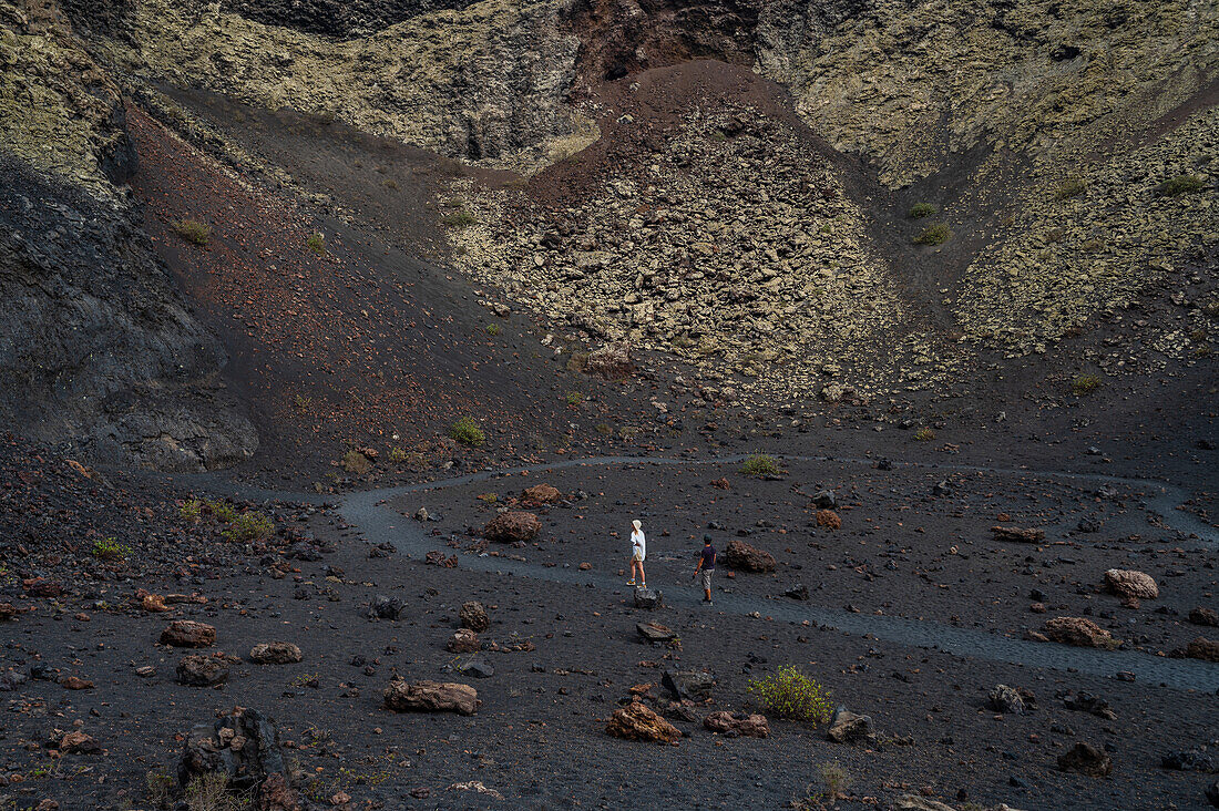 Volcan del Cuervo (Crow volcano) a crater explored by a loop trail in a barren, rock-strewn landscape