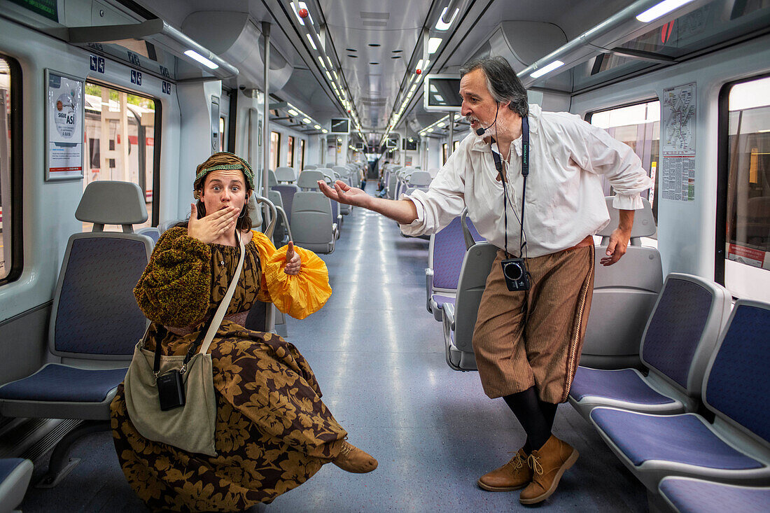 Actors performing Don Quixote de la Mancha and Dulcinea del Toboso inside the Cervantes Train between Atocha train Station and Alcala de Henares, Madrid Spain