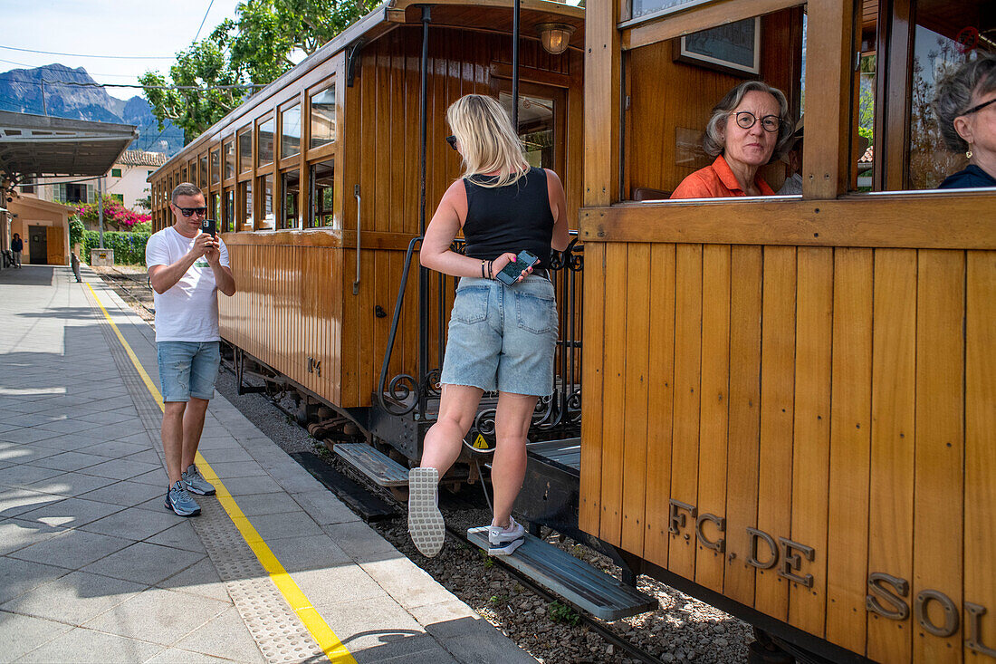 Tourists taken pictures in the tren de Soller train vintage historic train that connects Palma de Mallorca to Soller, Majorca, Balearic Islands, Spain, Mediterranean, Europe.