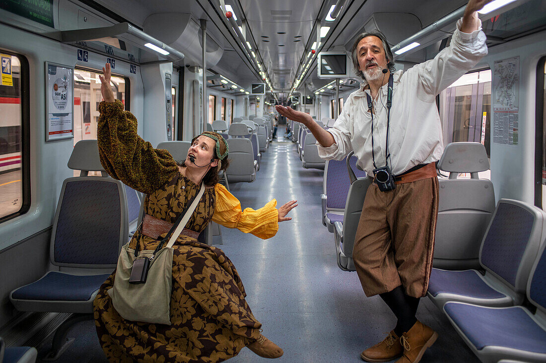 Actors performing Don Quixote de la Mancha and Dulcinea del Toboso inside the Cervantes Train between Atocha train Station and Alcala de Henares, Madrid Spain